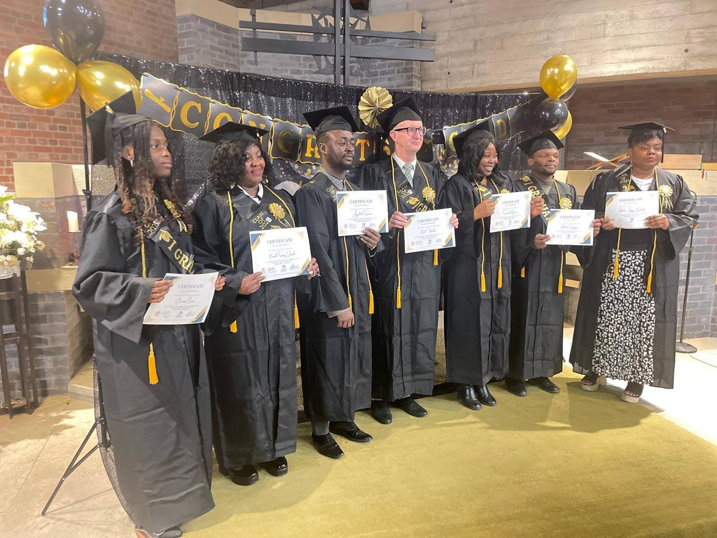 School of Spiritual Maturity graduates celebrating with certificates